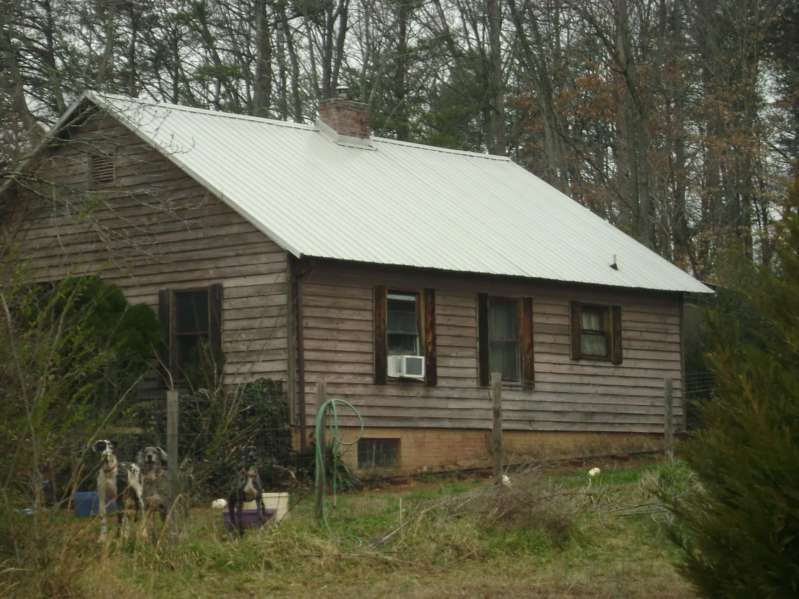 White metal roof on an old wood sided farmhouse, from a Metal Roof Installation job in Indian Hills